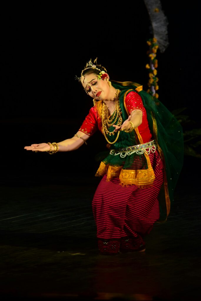 Graceful dancer in Indian traditional attire performing on stage, capturing cultural heritage.