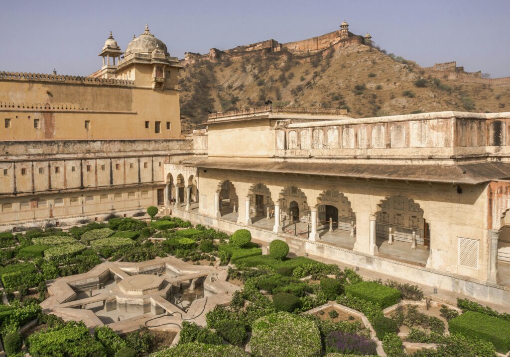 Aerial view of the intricate gardens at Amber Fort, Jaipur, Rajasthan, India, under clear skies.