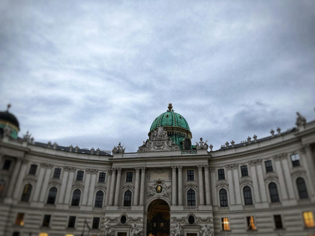 Capture of the magnificent dome of Hofburg Palace in Vienna under a moody sky.