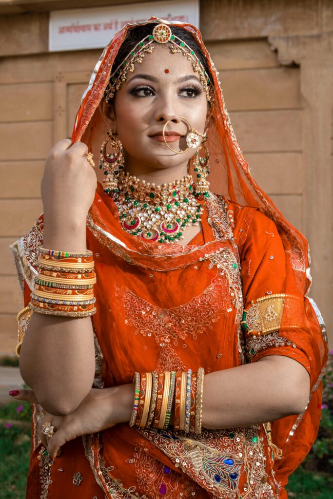 Elegant portrait of a woman in traditional Indian attire, showcasing rich cultural jewelry.