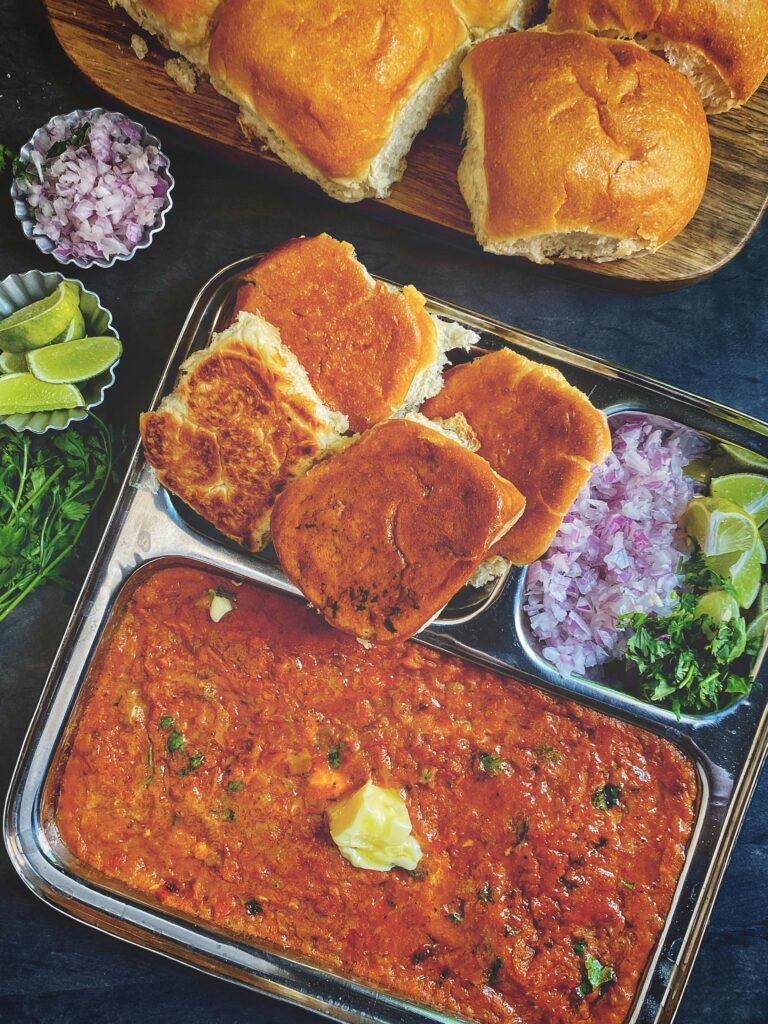 Delicious spicy pav bhaji with garnishes, perfect for a flavorful Indian lunch.