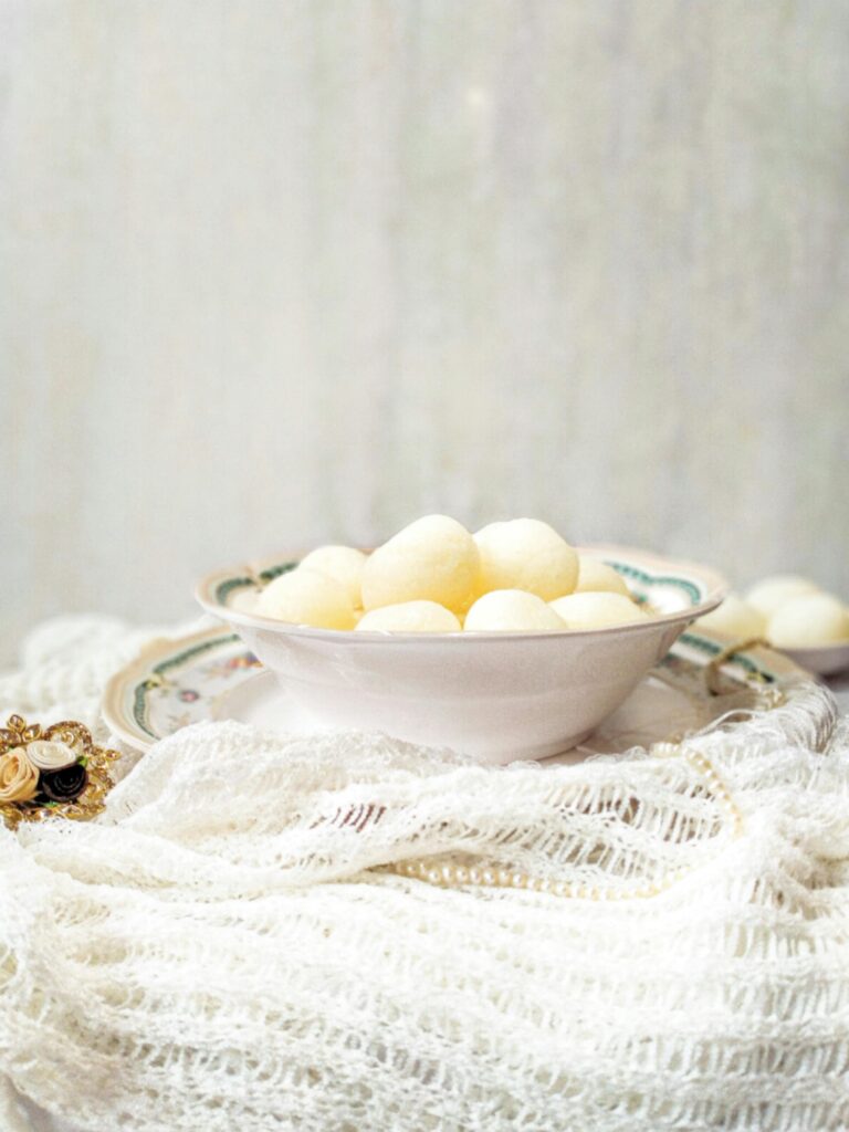Delicious homemade rasgulla dessert in an elegant bowl, showcasing traditional Indian cuisine.
